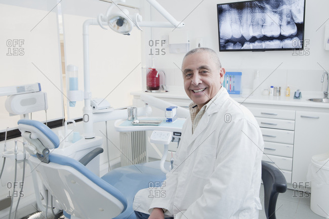 Dentist smiling in dentist's surgery