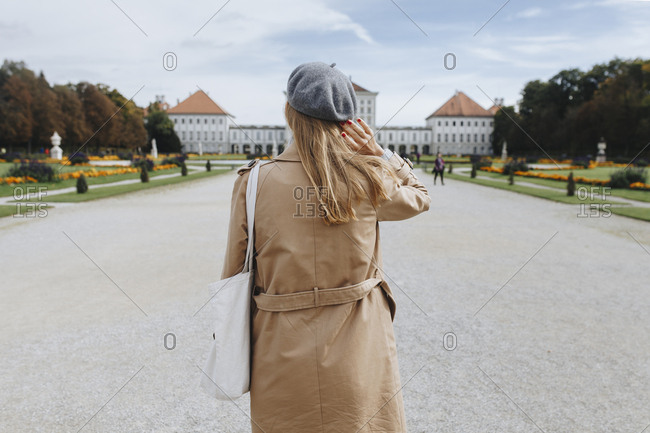 Woman wearing coat and beret by Nymphenburg Palace in Munich, Germany