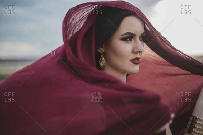 Windswept woman wearing red headscarf and lipstick