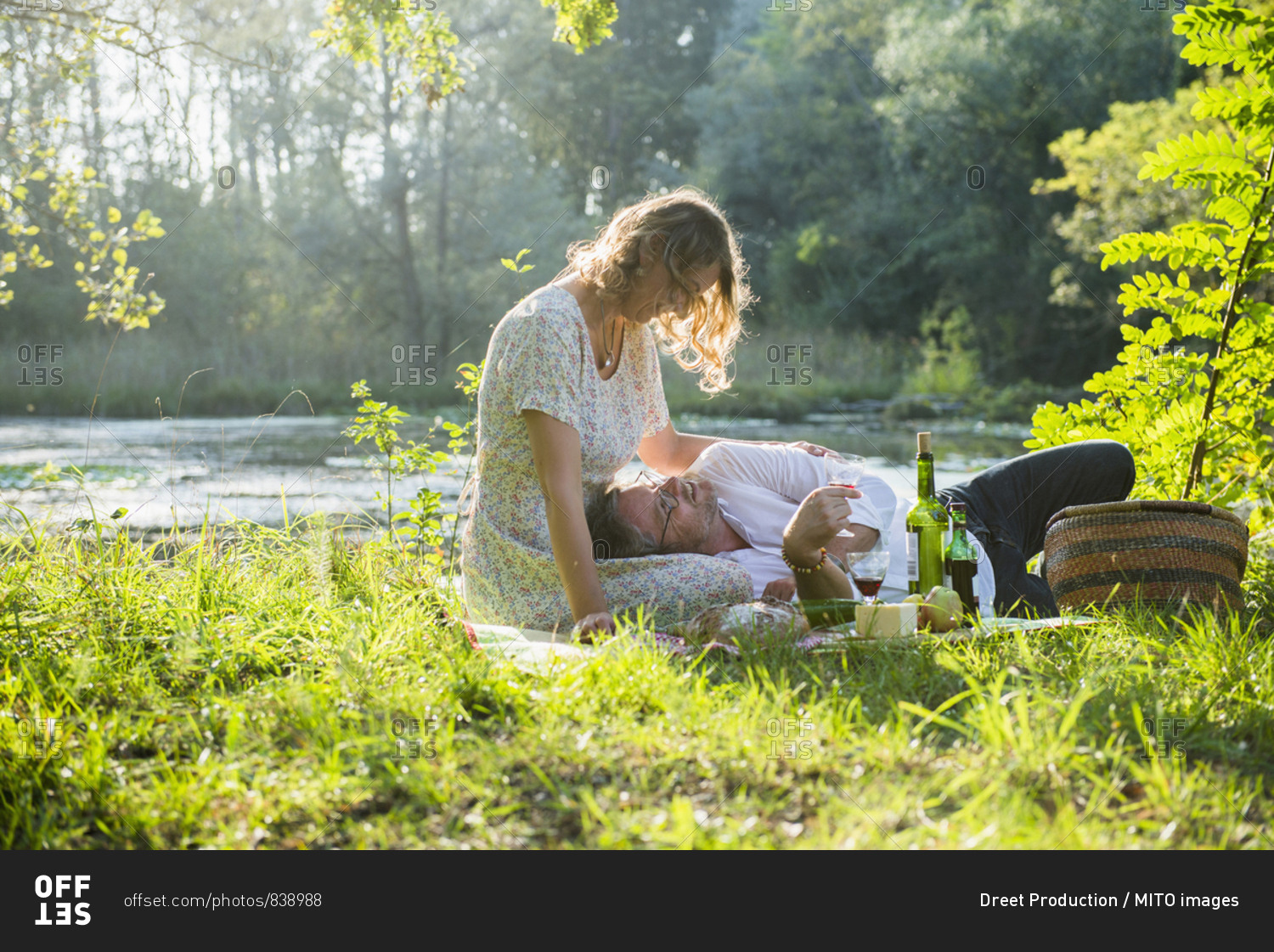 Romantic couple enjoying picnic by lake, Germany