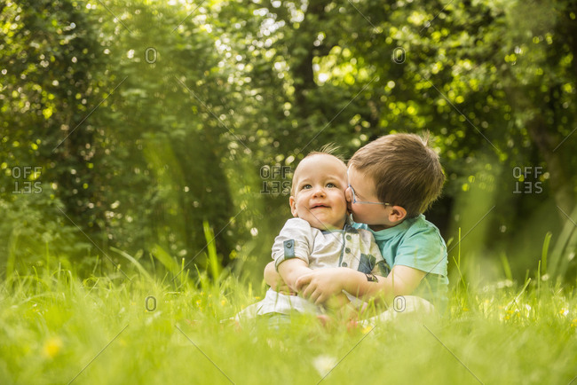 Two little brothers having fun in the garden