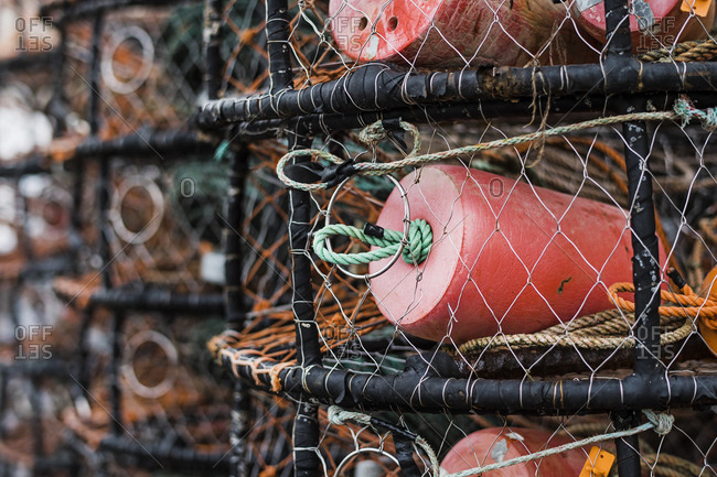Crab and lobster pots stacked up on the quayside, close up.