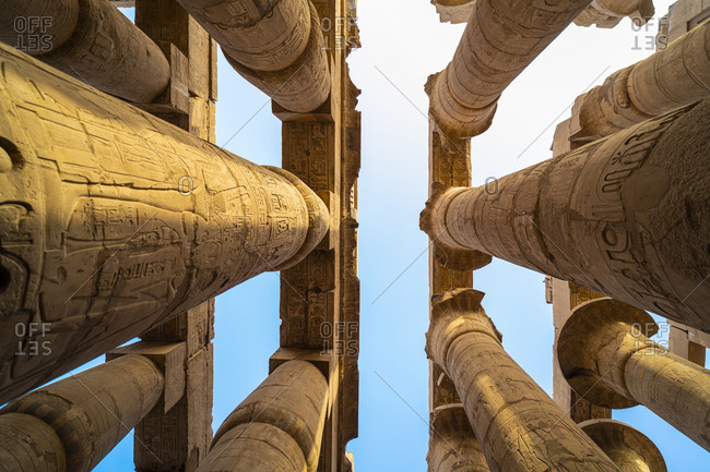 Pillars decorated with Hieroglyphics in the Great Hypostyle Hall of the ancient Karnak Temple in Luxor