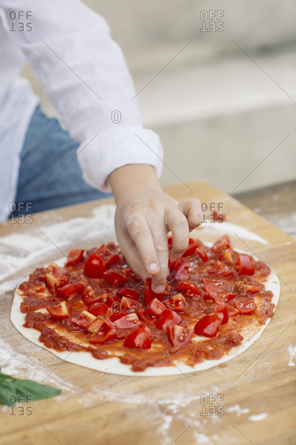 Boy preparing pizza