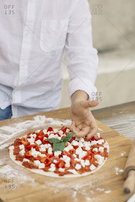 Boy preparing pizza