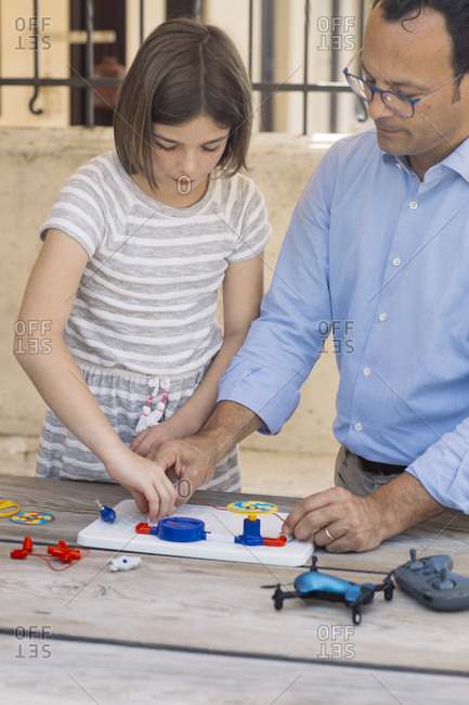 Father teaching his daughter electronics and robotics