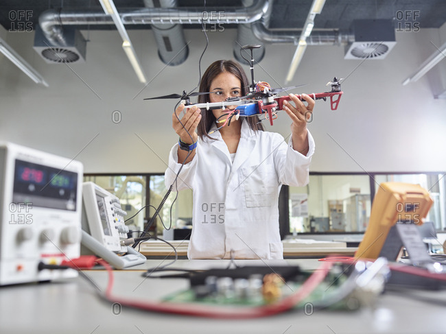 Female technician working in research laboratory- holding drone