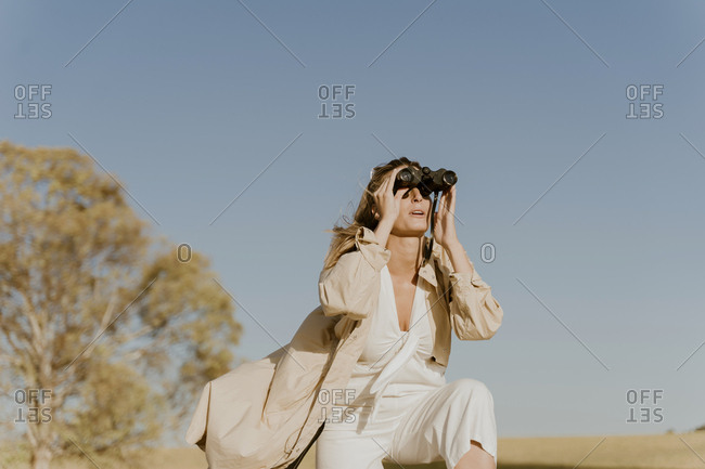 Female traveller looking through binoculars
