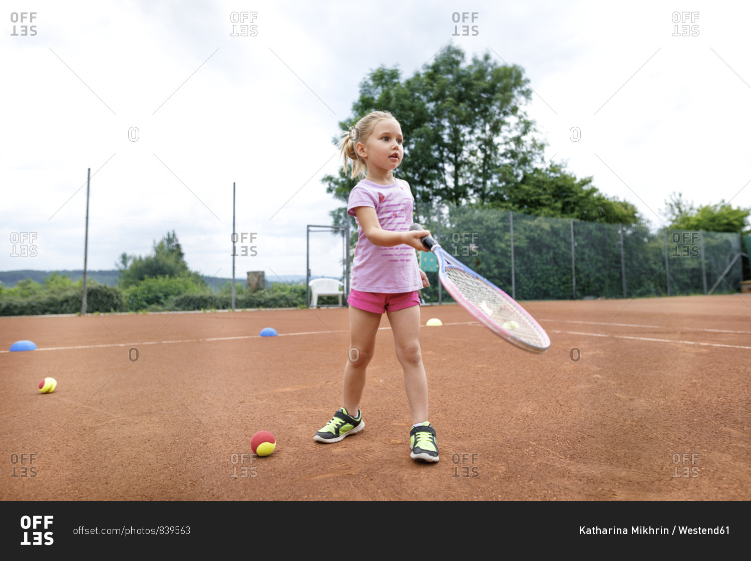 Little girl- lerning to play tennis