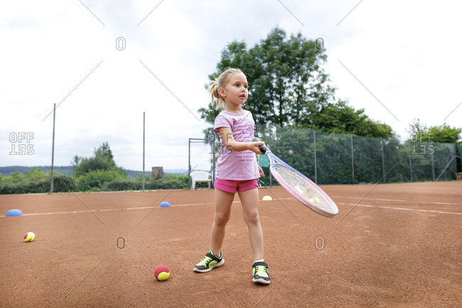 Little girl- lerning to play tennis