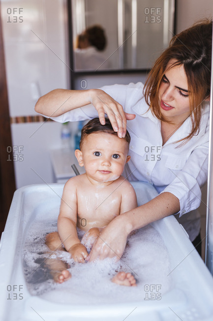 Mother bathing her little son