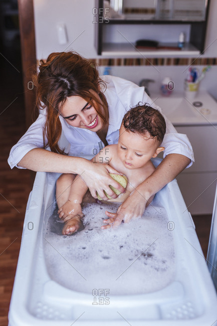 Mother bathing her little son