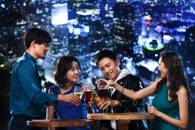 Happy young people drink at the bar