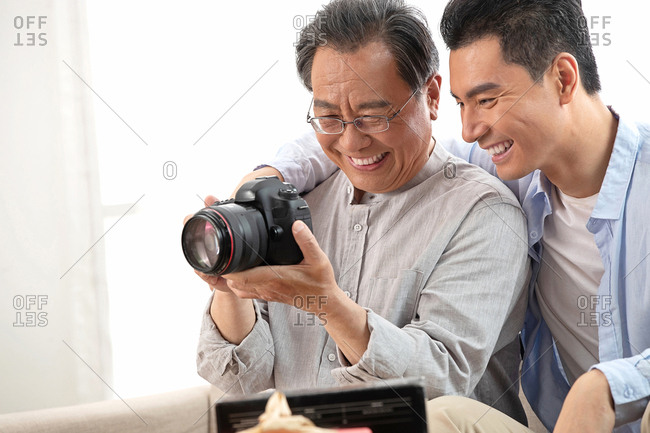 Happy father and son to see the camera