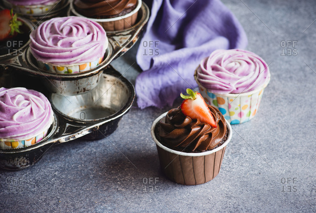 Chocolate and blueberry cupcakes with cream cheese frosting, selective focus