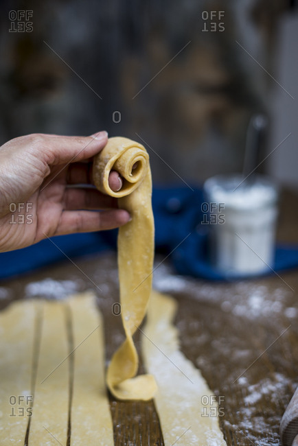 Hand rolling dough to make oudnin el kadi, a Tunisian pastry