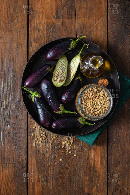 Raw eggplants on wooden table top view. Cooking fried eggplant concept