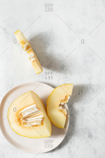 Cut of juicy melon on white background top view