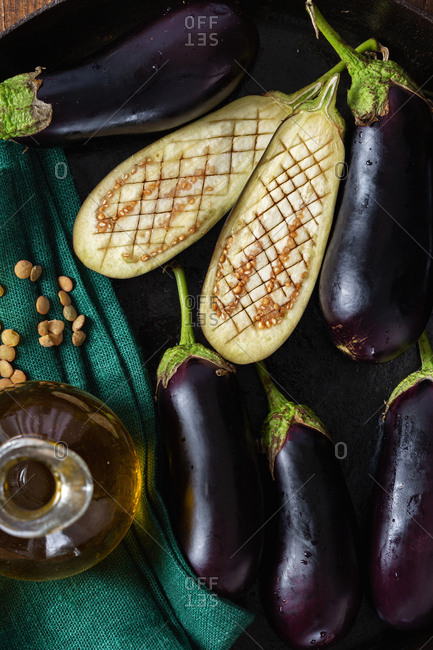 Raw eggplants on wooden table top view. Cooking fried eggplant concept
