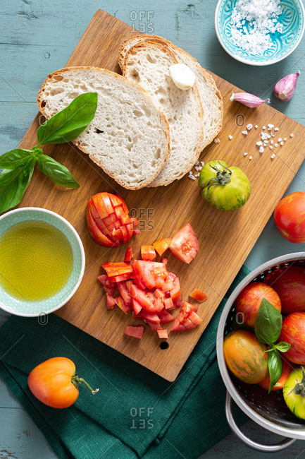Ingredients for cooking bruschetta with with tomato, olive oil and basil