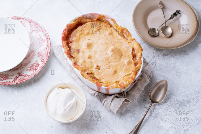 Peach cobbler with hot sugar crust and whipped cream