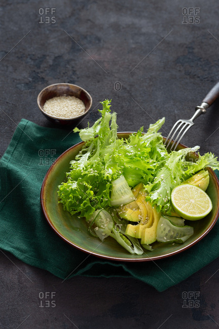 Plate with diet salad on a dark background close up