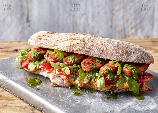Chorizo ciabatta with roasted peppers, chimichurri, romesco mayo and rocket