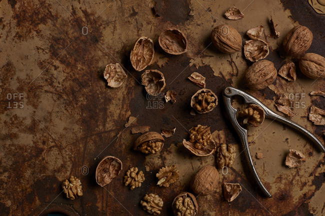 Walnuts bein broken on rusty metal surface