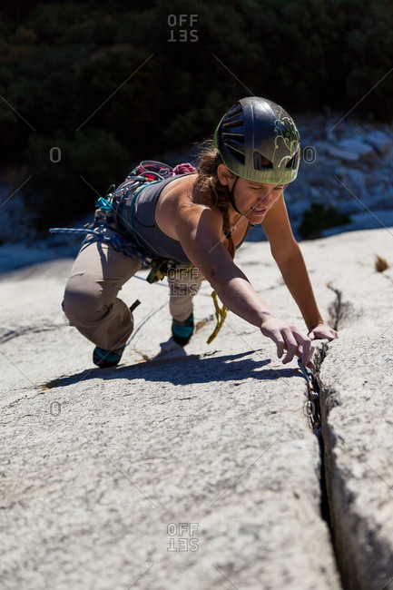 Woman climbing on mountain, Yosemite National Park, California
