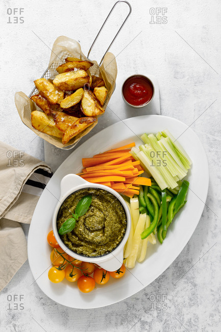 Vegetables snacks served in plate on a white background with fried potatoes