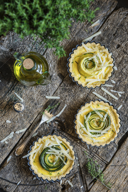 Savoury tartlets with courgette and parmesan in a baking dish