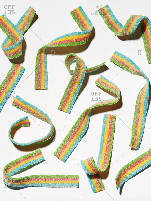 Four-colored fruit gum strips on a white background
