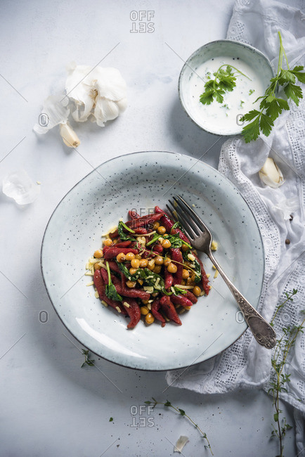 Beetroot orzo pasta with chickpeas, spinach and herb sauce (vegan)