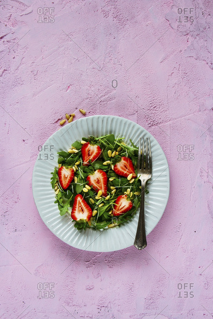 Strawberry salad plate with arugula pine nuts and micro greens