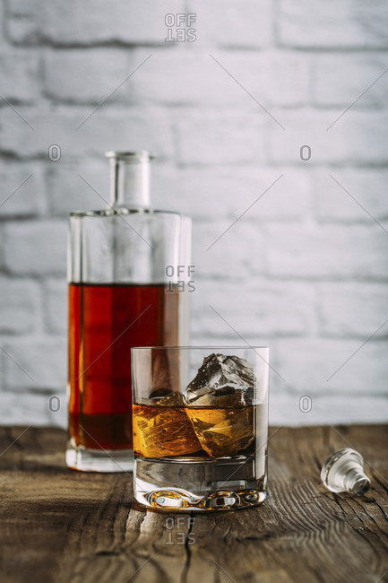 Glass of whiskey on a wooden table