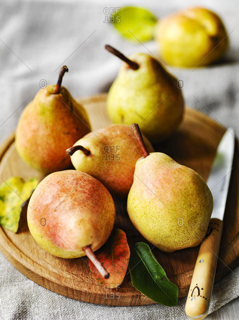 Autumn Comice pears on board with fruit knife
