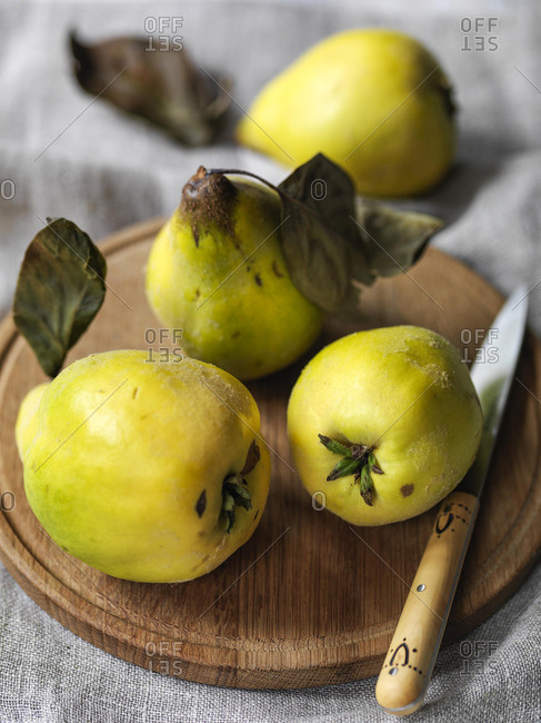 Quinces on board with knife