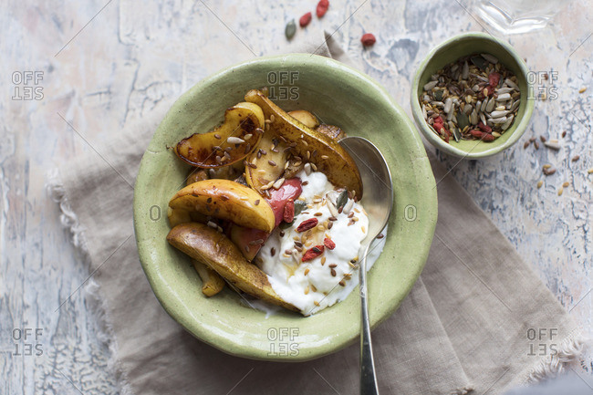 Baked apple and pear slices served with yoghurt, goji and seeds