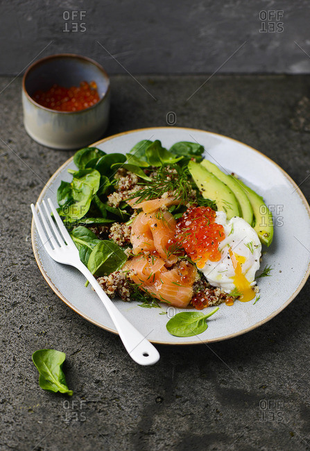 Quinoa salad with spinach, avocado, salmon and caviar