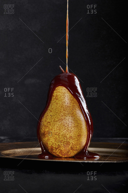 Chocolate pouring on a ripe pear