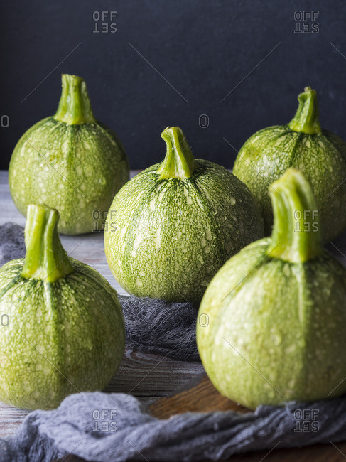 Raw round zucchini on wooden table