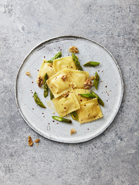 Goat's cheese ravioli with green asparagus, walnuts, chilli flakes and olive oil