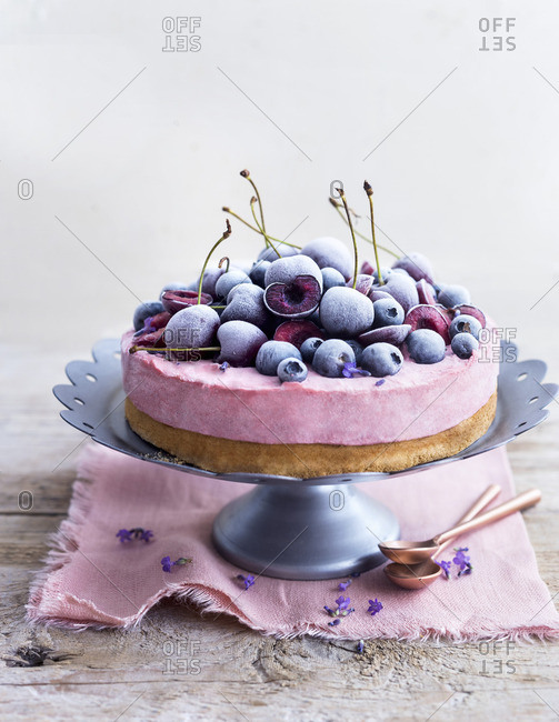 Cherry cream cheese cake with frozen cherries and blueberries