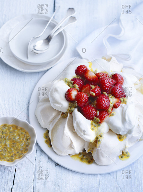 Pavlova with fresh strawberries and passion fruit