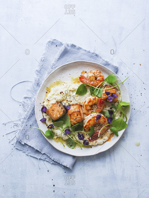 Quinoa risotto with fried salmon and prawns