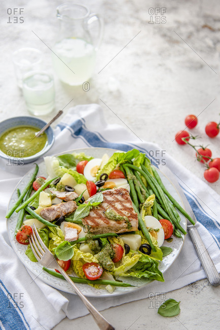 Tuna salad with eggs, olives, tomatoes, beans and Nicoise dressing