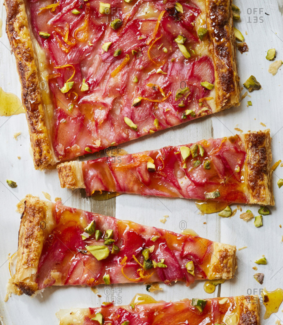 A rhubarb tart that has been cut up into pieces