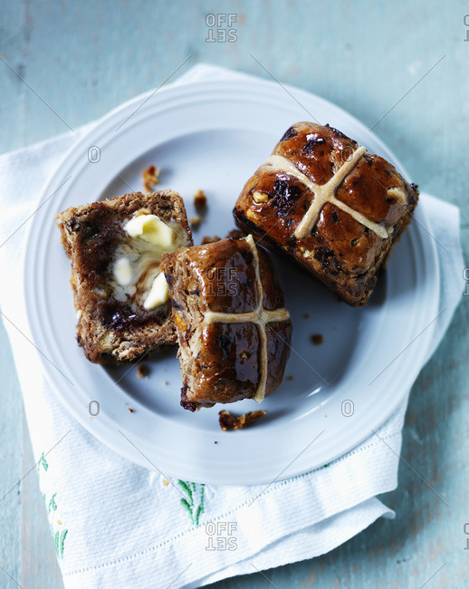 Hot cross buns with icing, chocolate, and raisins