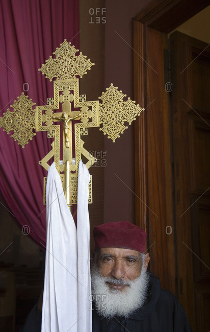 Addis Ababa, Ethiopia - January 17, 2007: Christian priest holding ornate gold crucifix