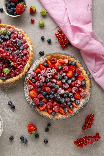 Top view of two freshly made berry tarts